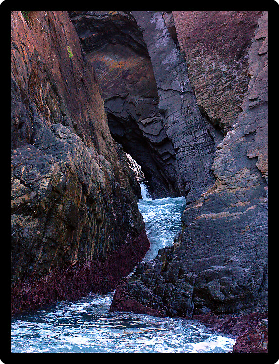 Waves crash through Seal Rocks Area of Booti Booti National Park in Australia.