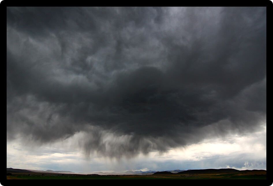 Dark clouds and precipitation from a thunderstorm in rural Idaho.