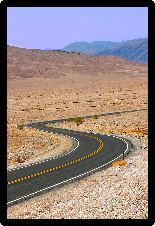 Long winding road through the hot deserts of Death Valley in California.