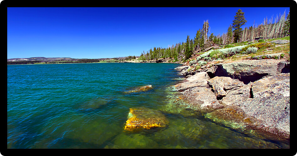 Cold blue waters of Yellowstone Lake on a sunny day in Yellowstone National Park.